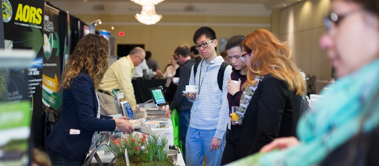 visitors to the Source to Stream Conference explore the trade show