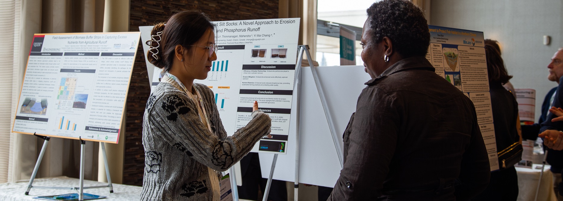 a Source to Stream conference delegate explores the student poster display